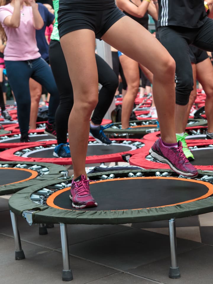 Women exercising on rebounders in fitness class