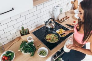 Woman cooking ketogenic diet foods on stove