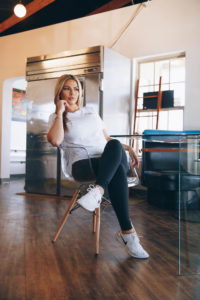 Woman in deep though sitting at kitchen table